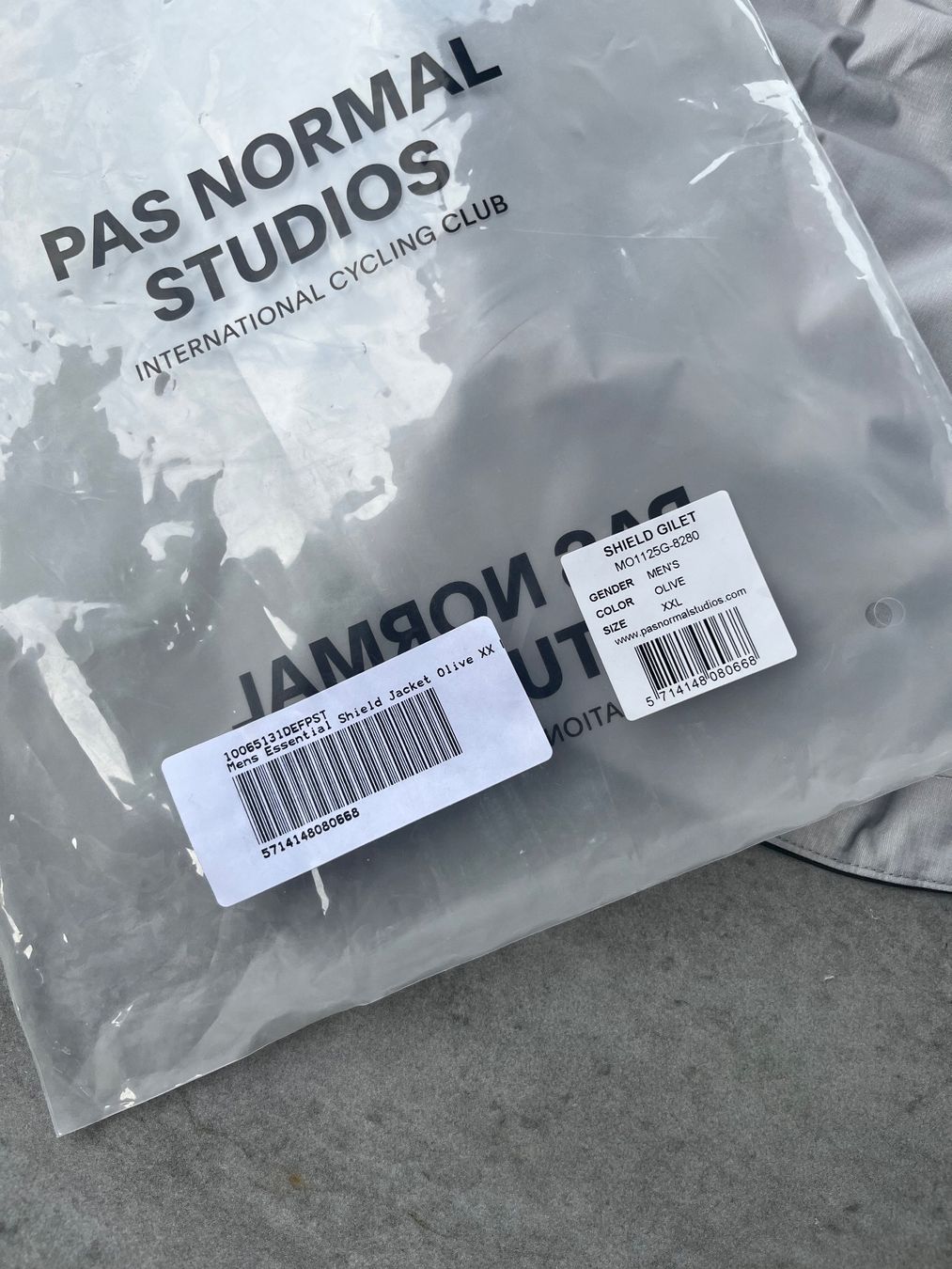 Pas Normal Studios Gilet & Giacche: Pas Normal Studios Herren Essential Shield Weste Oliv XXL – Nuovo e nell'imballaggio originale da Arbon venduto da Lakatusch 5