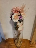 Standing floor glass vase with artifical flowers and pebbles