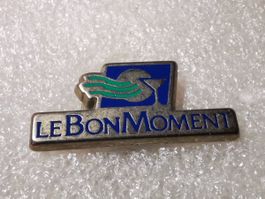 Ansteckpin 8: Le bon Moment