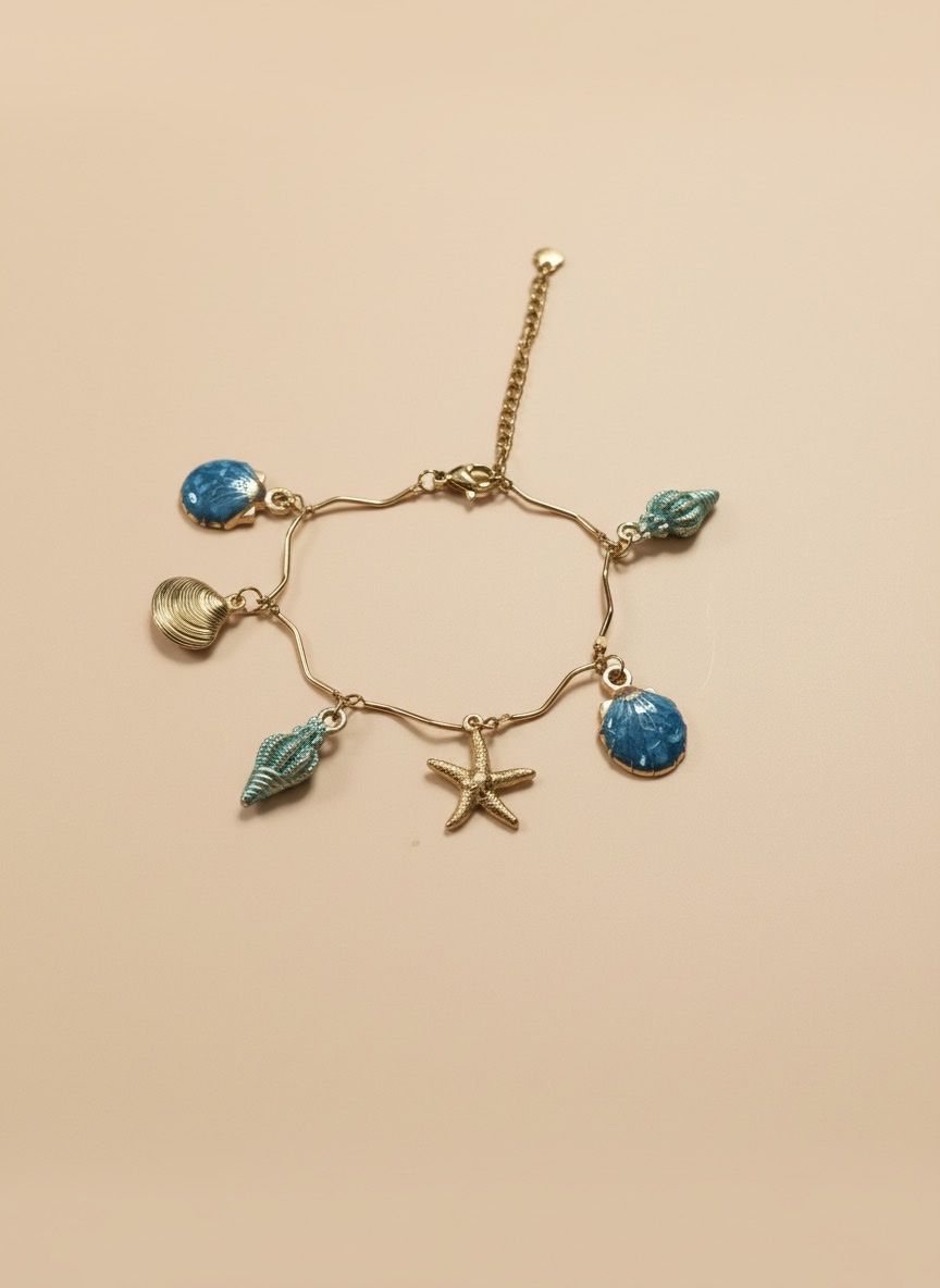 Bracciali & Braccialetti: Ocean-Themed Charm Bracelet: Seashells and Starfish Style – Nuovo e nell'imballaggio originale da Saland venduto da ele_vc96 1