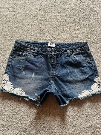 Vero Moda Women's Blue Denim Shorts with Lace Trim.