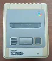 super nintendo avec une manette et câbles 