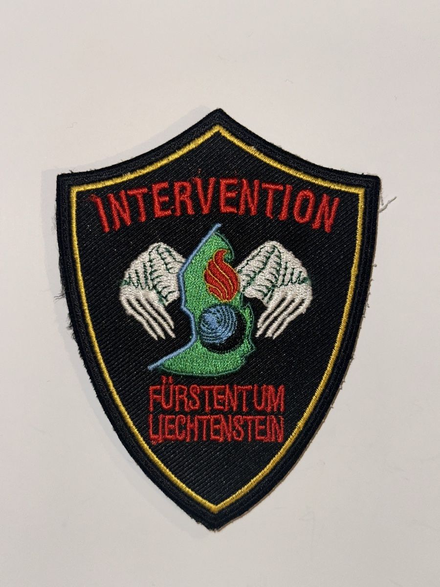 Swiss Placchette & Badge: Polizei Lichtenstein Interventionsgruppe – Nuovo e nell'imballaggio originale da Castione venduto da DWNL