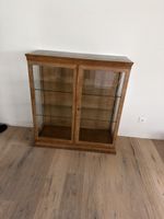 Antique wooden display case with glass shelves