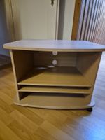 Meuble TV bois clair avec roulettes état correct