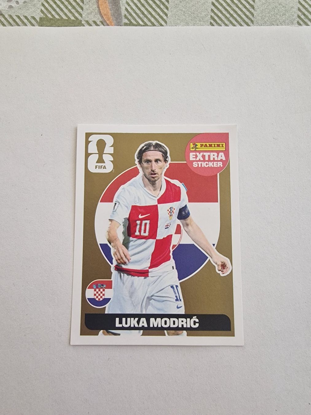 Panini Carte collezionabili: Panini WM 2026 extra Sticker - Modric in Gold – Nuovo (secondo la descrizione) da Adliswil venduto da vendor123