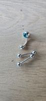 Schmuckstücke für den Sommer - Piercings mit blauen Steinen