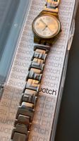 Montre Swatch avec bracelet métallique