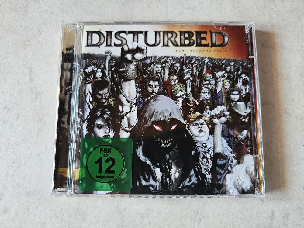 CD: Disturbed  -  Ten Thousand Fists  /  CD + DVD – Usato da Schneisingen venduto da backstore24