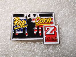 Ansteckpin 21: Zweifel Pop Corn
