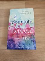 Roman "A mountain between us" von Jenni Krawiec