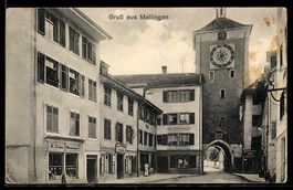 AK Mellingen, Strassenansicht mit Stadttor und Uhrturm, Hand