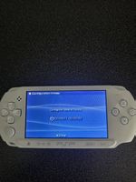Console Psp et 2 jeux.
