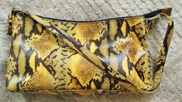 Pochette Nicoli en cuir de python véritable.