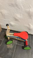 Wooden balance bike for children, red seat, green wheels