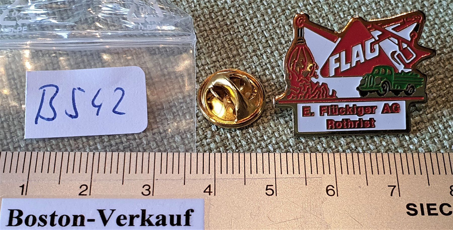 Placchette & Badge: B542 - Pin FLAG E. Flückiger AG Rothrist – Usato da Reinach BL venduto da Boston-Verkauf 2
