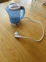 Small kettle with mugs and spoons