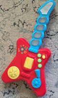 Childrens toy guitar red blue good condition