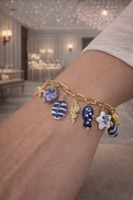 Bracciale charm oro stile mare con conchiglie e stelle