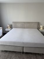 Full bedroom with box spring, side tables and carpet 