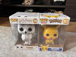 Two big funko pops,pikachu and hedwig
