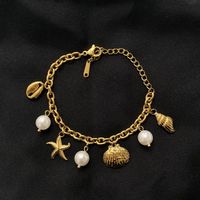 18KGP Muschel und Perlen Charms Armkette