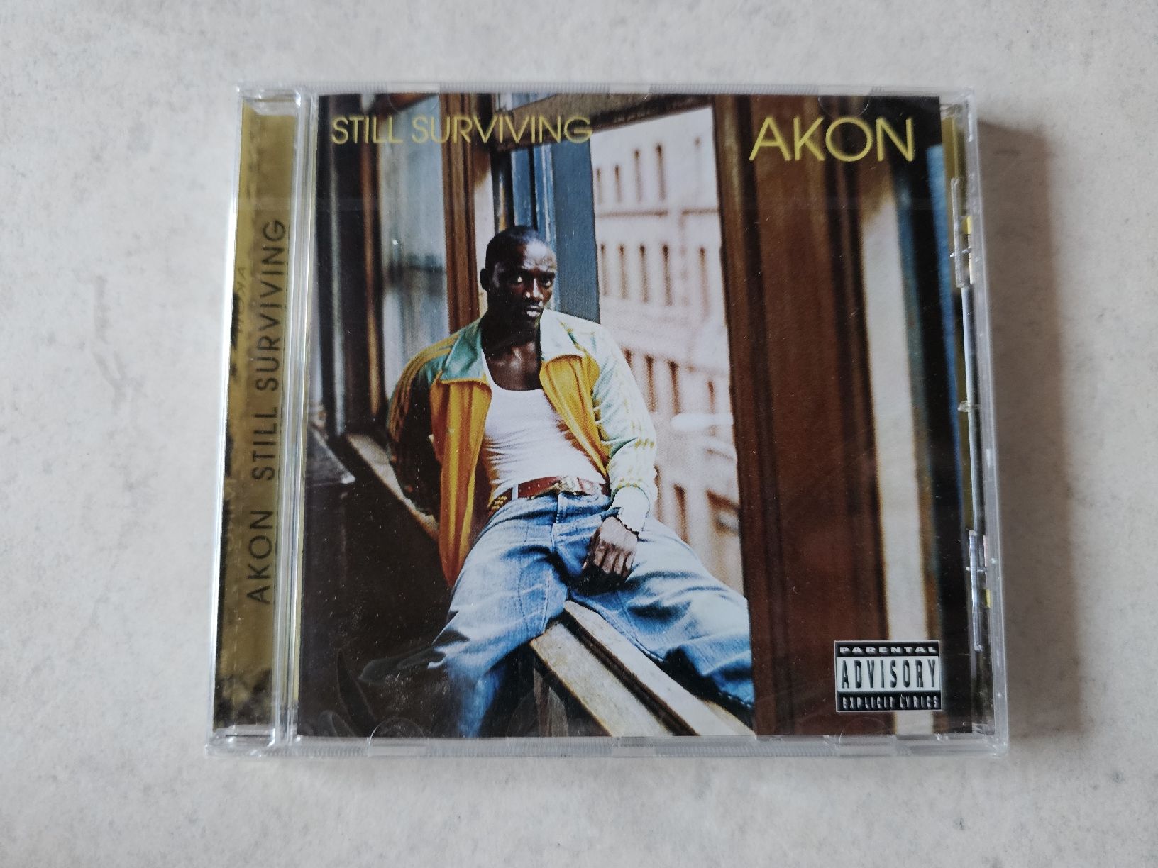 CD: Akon  -  Still Surviving  /  Fabrikneu – Nuovo e nell'imballaggio originale da Schneisingen venduto da backstore24