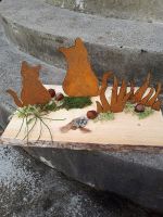 Sitzende Katzen aus Rostblech