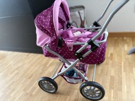 Puppe und Puppenwagen