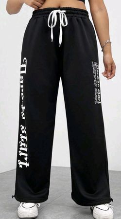 Jogging noir ample avec inscriptions, taille 48