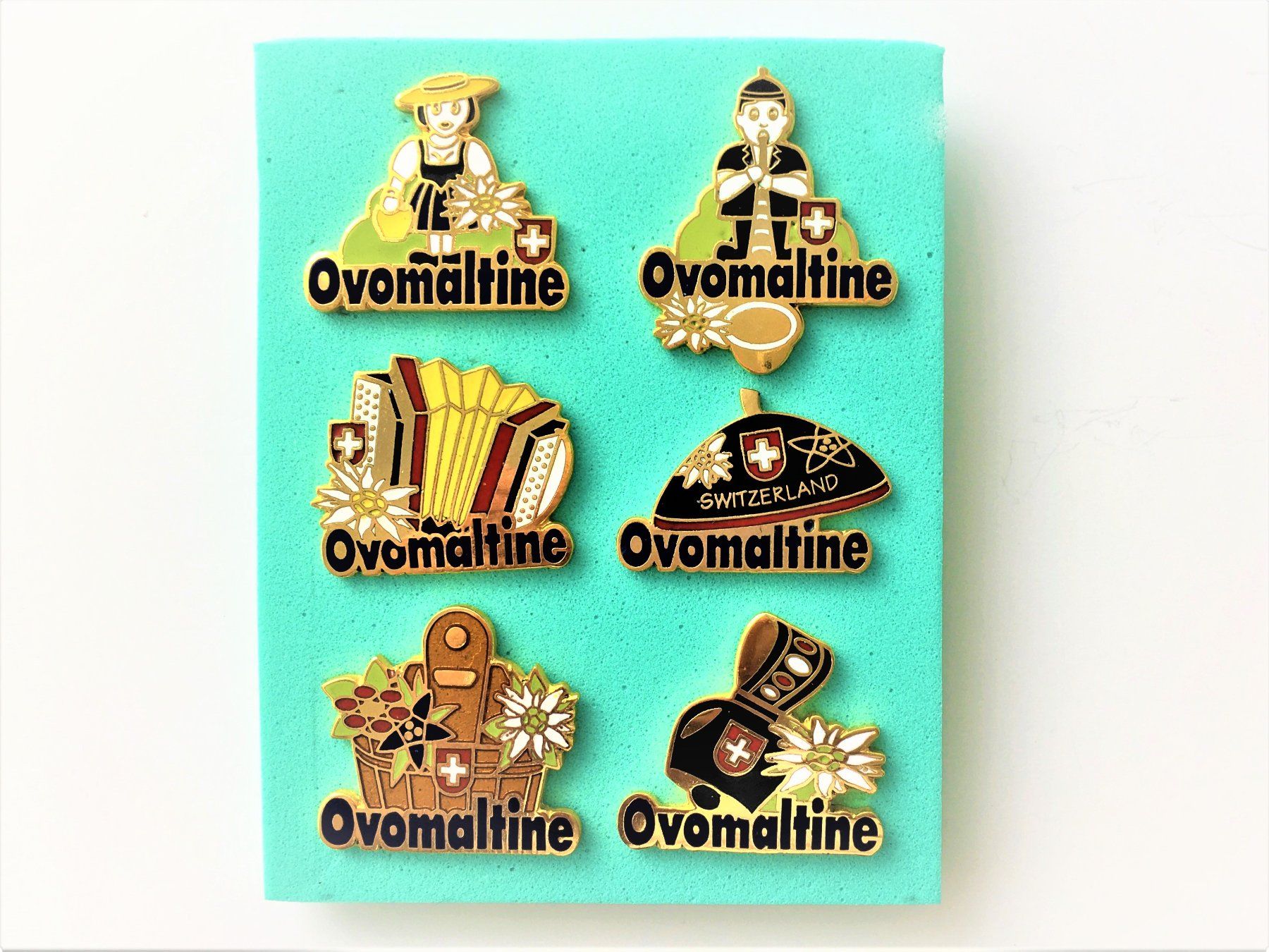 Placchette & Badge: 6 ver. Pin's von Ovomaltine – Usato da Oberaach venduto da feggi