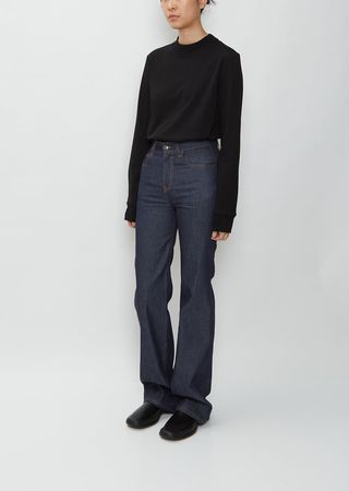 The Row High-Rise Flared Jeans — Raw Dark Indigo