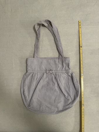 Borsa Subdued con fiocco a coste lilla chiaro.