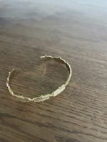 Bracciale rigido dorato con inserti