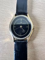 Montre femme Universal Genève, cadran noir, plaqué or