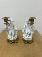 2 Kerzenständer aus Biskuitporzellan/Messing Putten um 1900