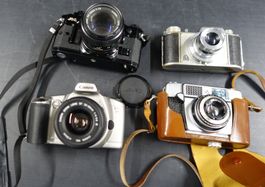 Kameraset: Canon EOS 3000N, Canon A-1, 2x Kleinbildkameras