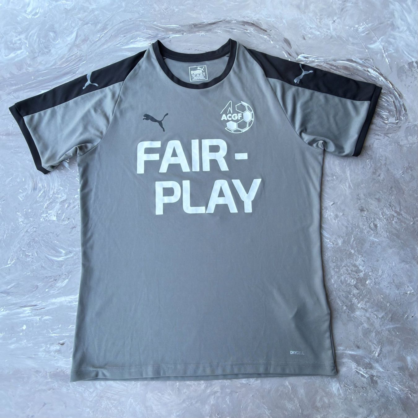 Puma T-shirt: T-shirt Puma ACGF Fair Play gris – Usato da Thônex venduto da Suisse.Shopping