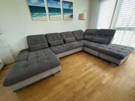 Ecksofa mit Schlaffunktion und Bettkasten grau