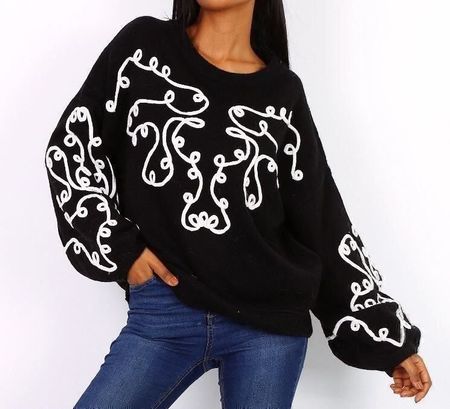 Pull noir motif blanc