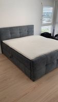 Boxspringbett dunkelgrau gepolstert mit Bettkasten