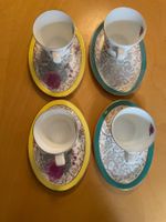 Vier Good Earth Teetassen und Untertassen