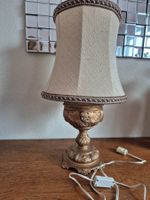 Lampe de chevet vintage dorée avec abat-jour textile.