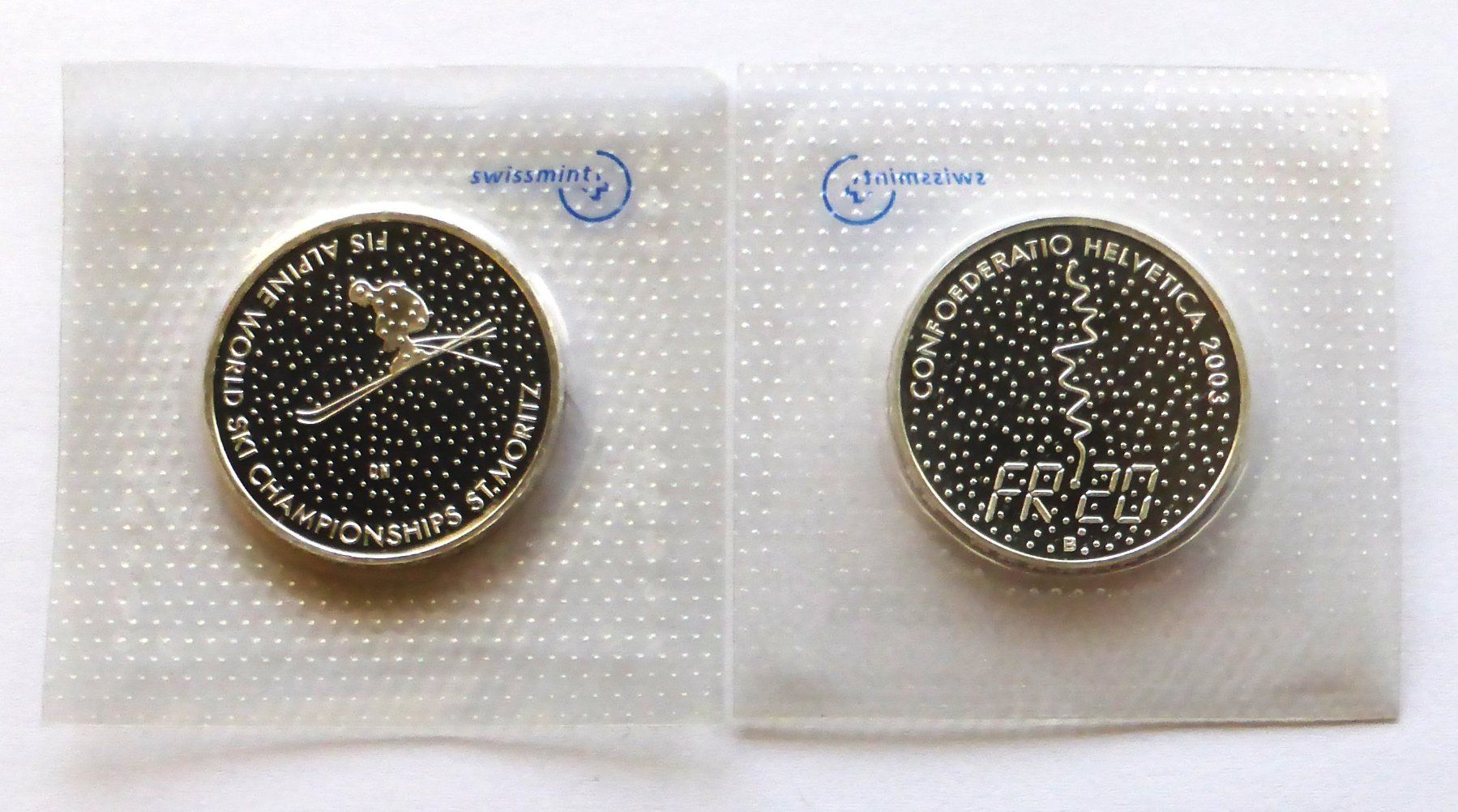 Tutti le monete: 20Fr. 2003 - FIS Ski - St. MORITZ – Nuovo e nell'imballaggio originale da Buochs venduto da ema-coins 1