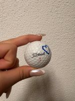 18 golf balls with distinctive drawings