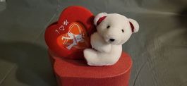 Weißer Plüsch-Teddybär mit herzförmigem Bilderrahmen