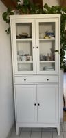 White IKEA display cabinet with glass doors and drawers