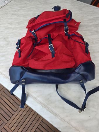 Backpack red blue nylon imitation leather details.