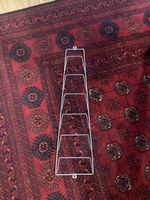 Wall mounted metal magazine rack silver coloured used