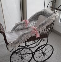 Vintage Puppenwagen aus Korbgeflecht.